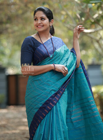 The graceful teal blue saree highlighted with a deep navy border blended silk saree